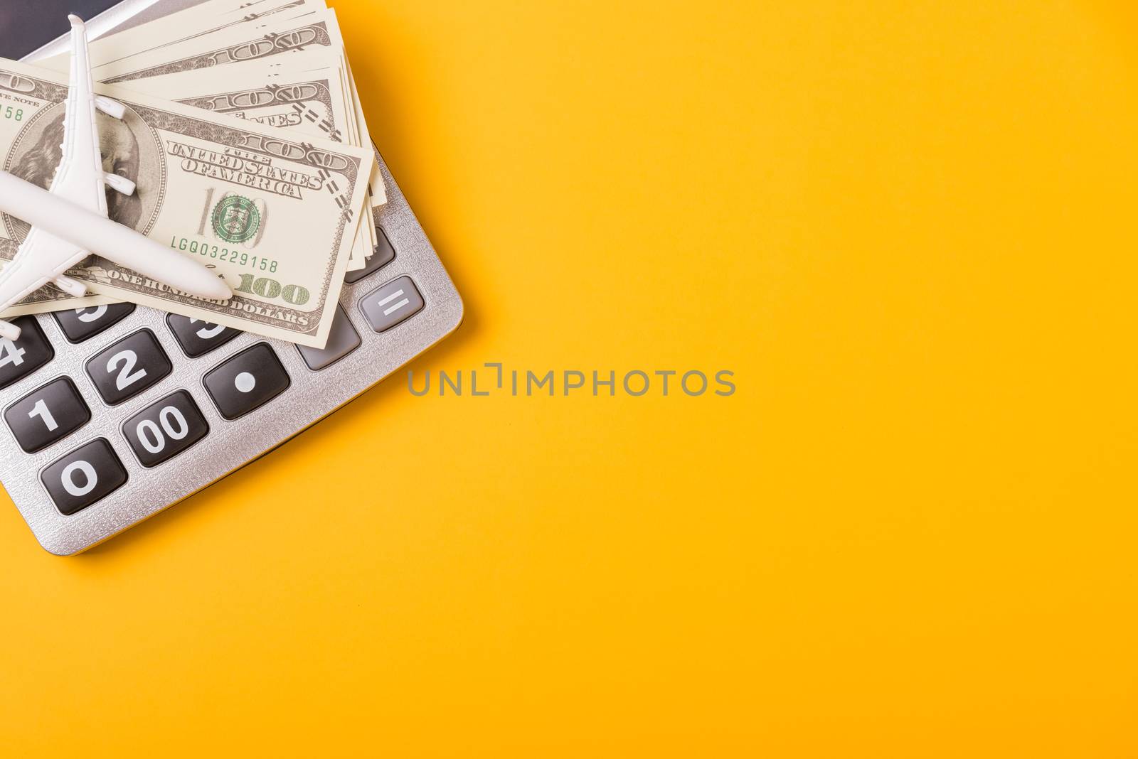 April of the year is Tax Day, Top view flat lay closeup calculator and Dollar money, on yellow background business finance budget concept with copy space for text