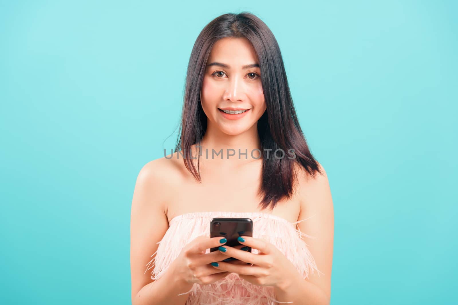 Portrait asian beautiful woman her typing message and smiling by Sorapop