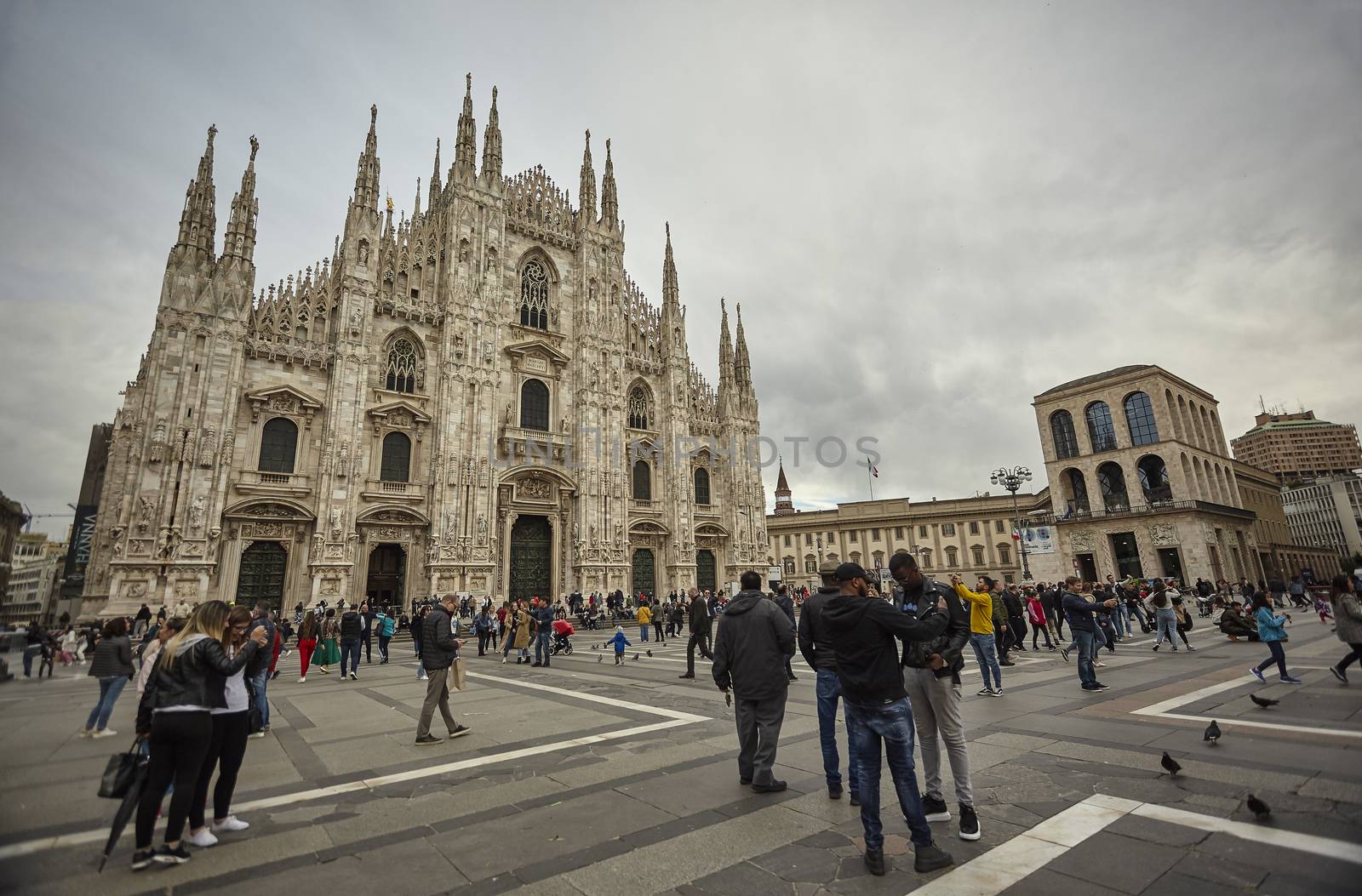 Milan Cathedral with tourists and people strolling en masse on the square 3 by pippocarlot