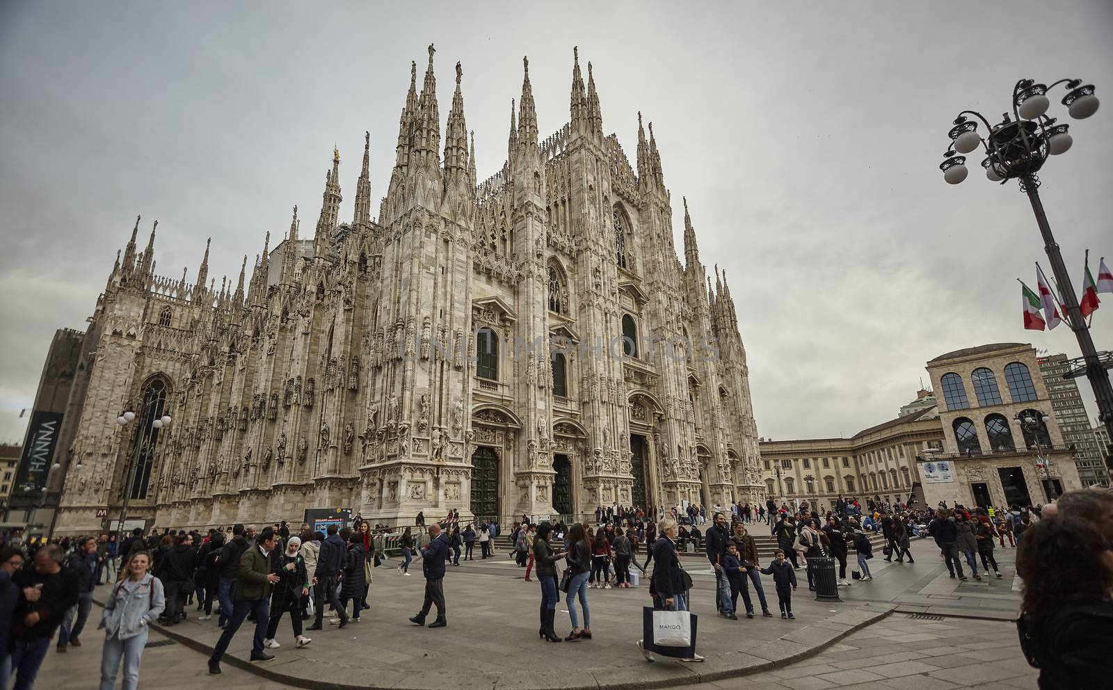 Milan Cathedral with tourists and people strolling en masse on the square by pippocarlot