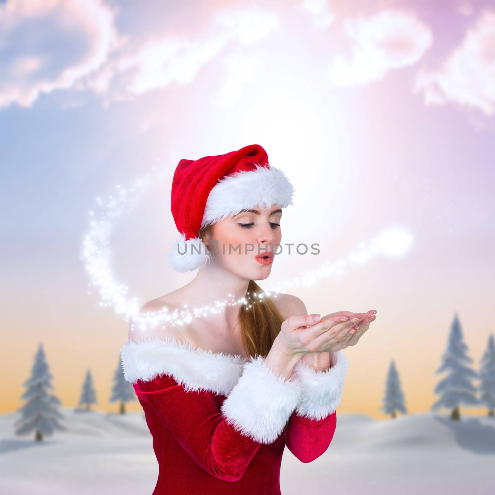 Composite image of pretty girl in santa costume holding hand out by Wavebreakmedia