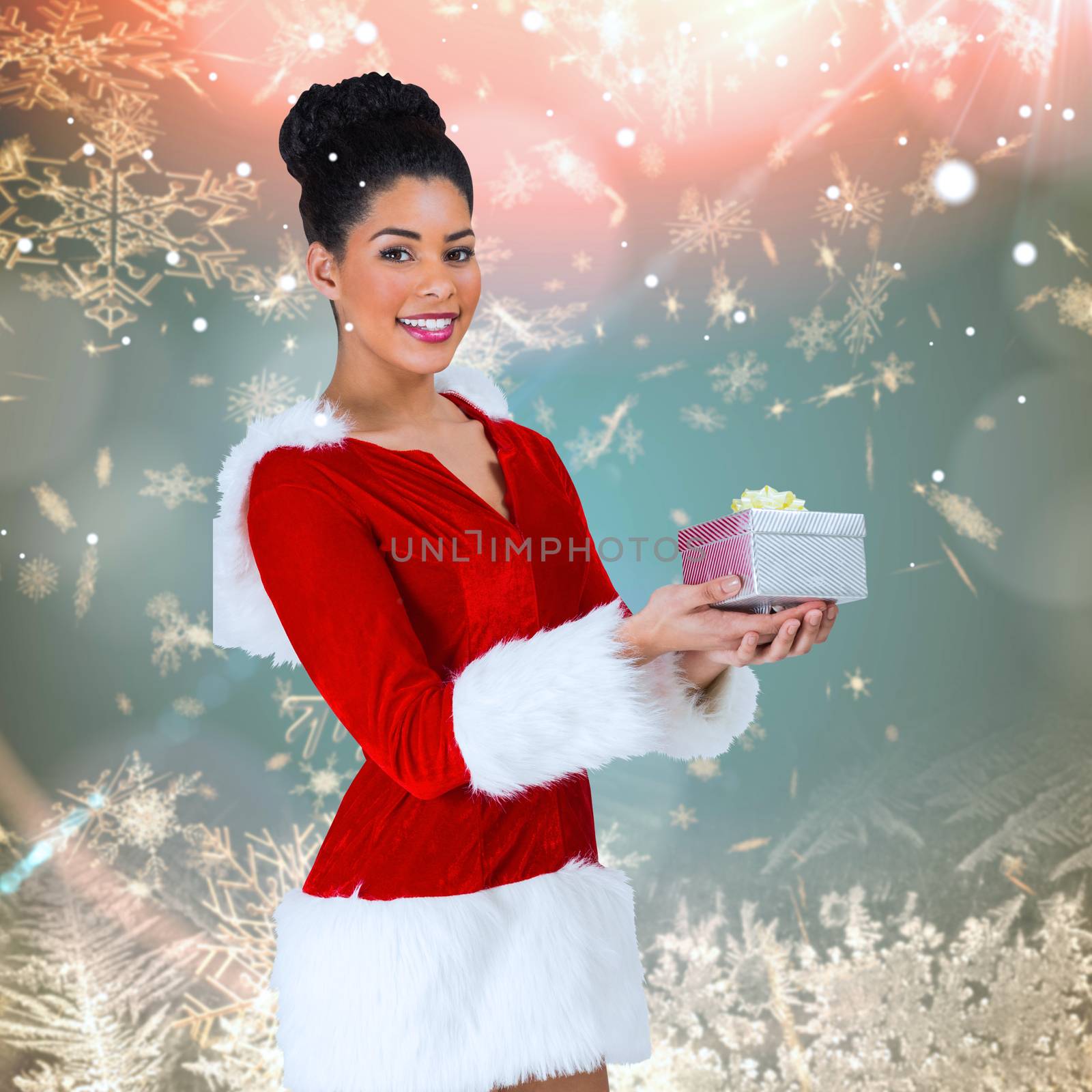 Composite image of pretty santa girl holding gift by Wavebreakmedia