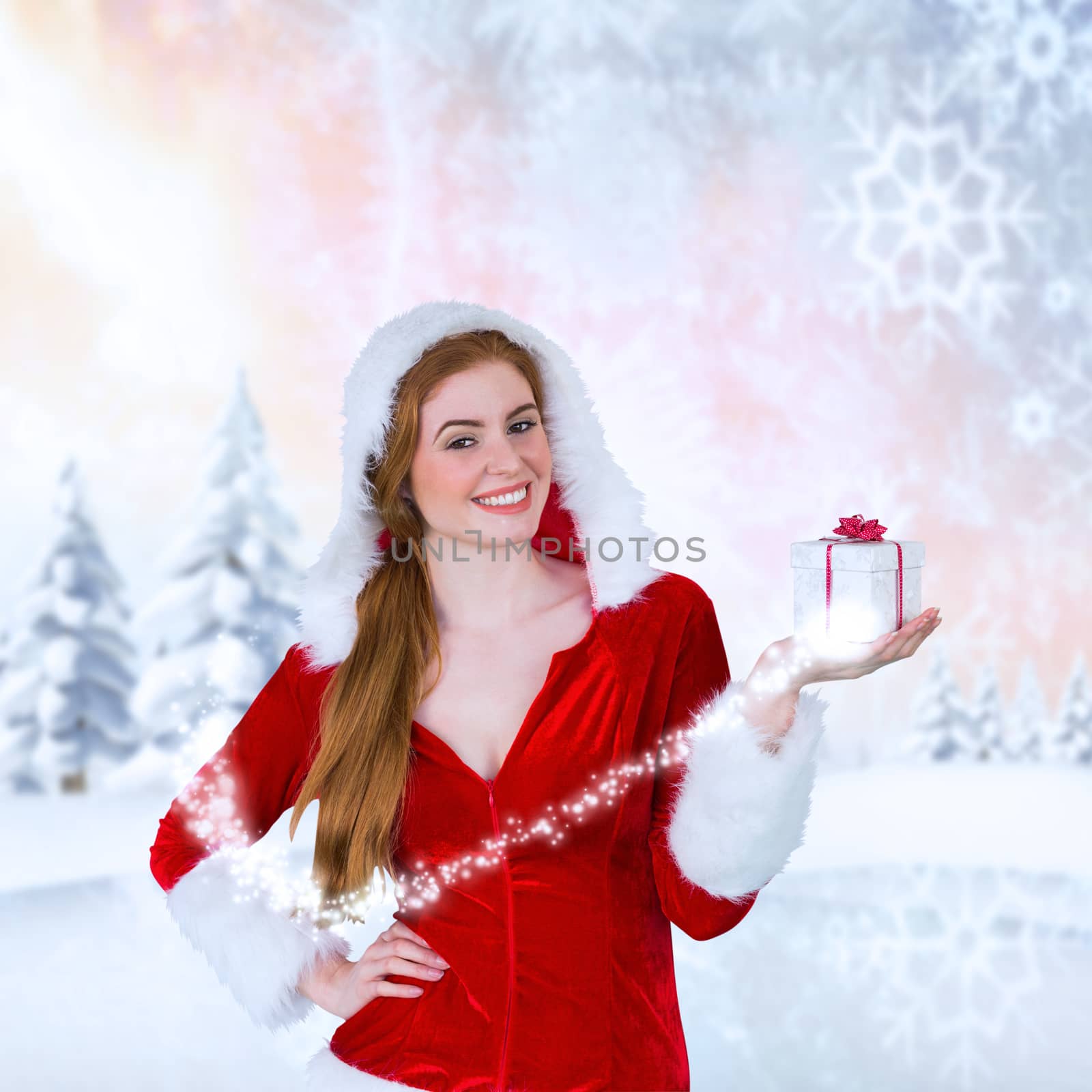 Composite image of pretty girl in santa costume holding gift box by Wavebreakmedia