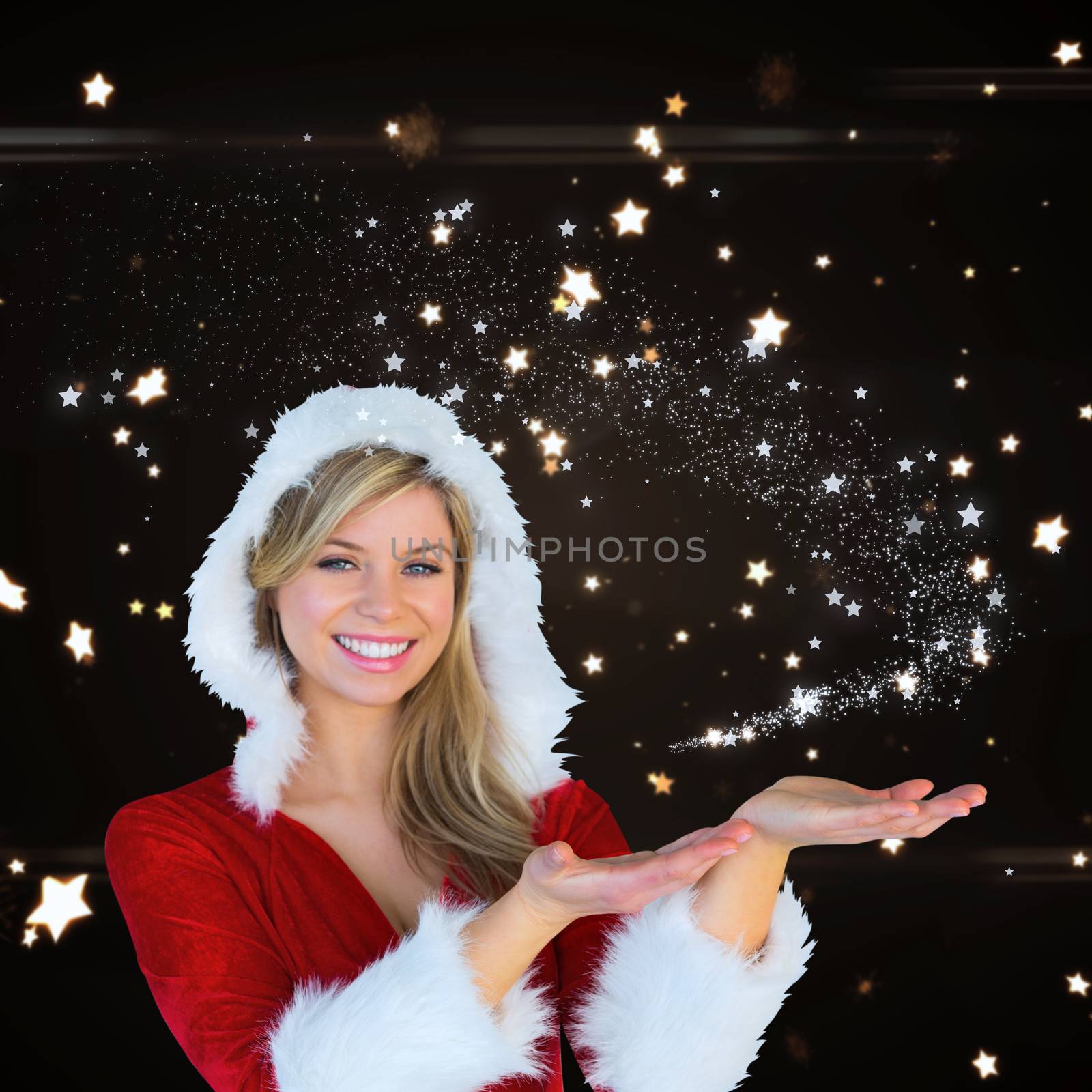 Composite image of pretty girl presenting in santa outfit by Wavebreakmedia