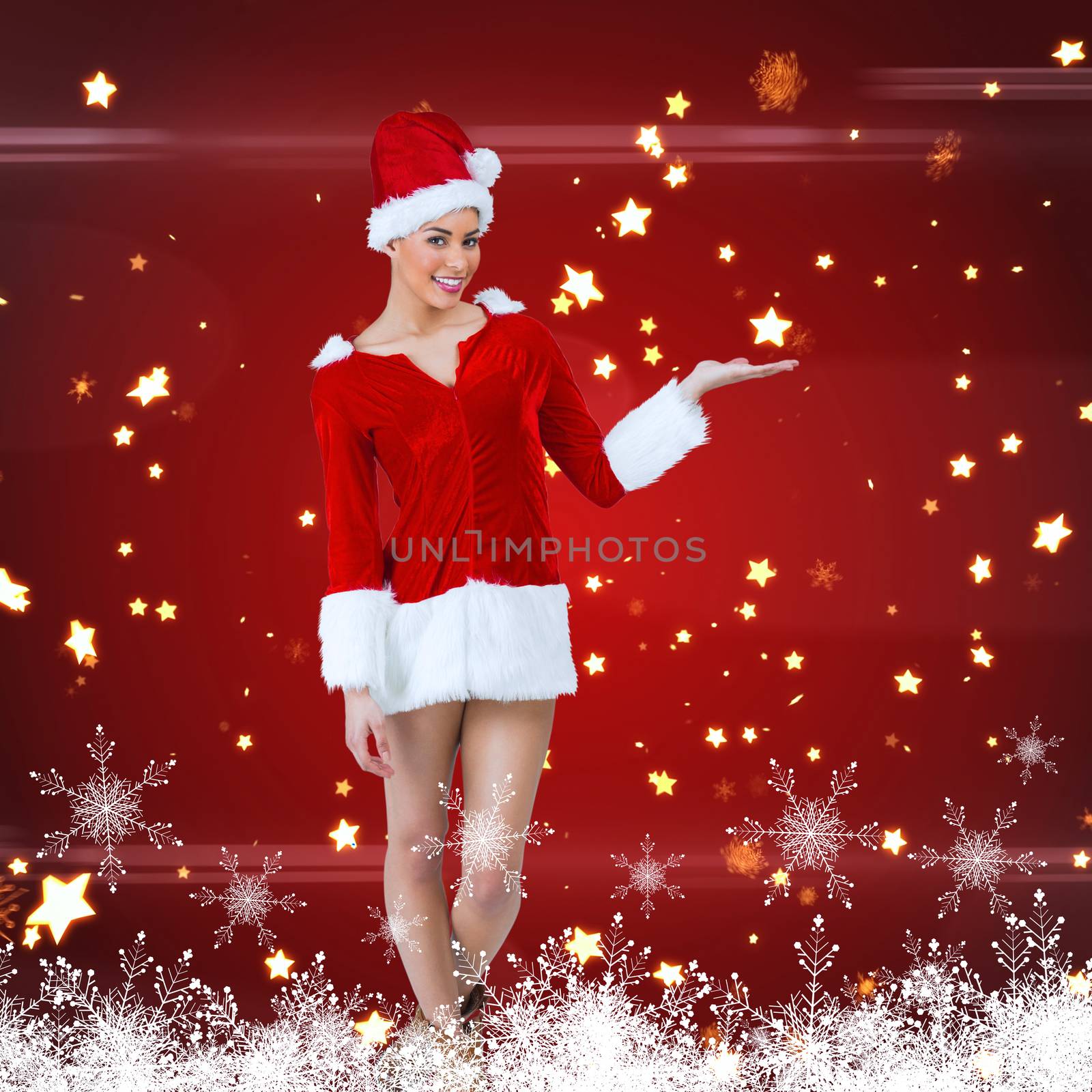 Pretty santa girl presenting with hand against bright star pattern on red