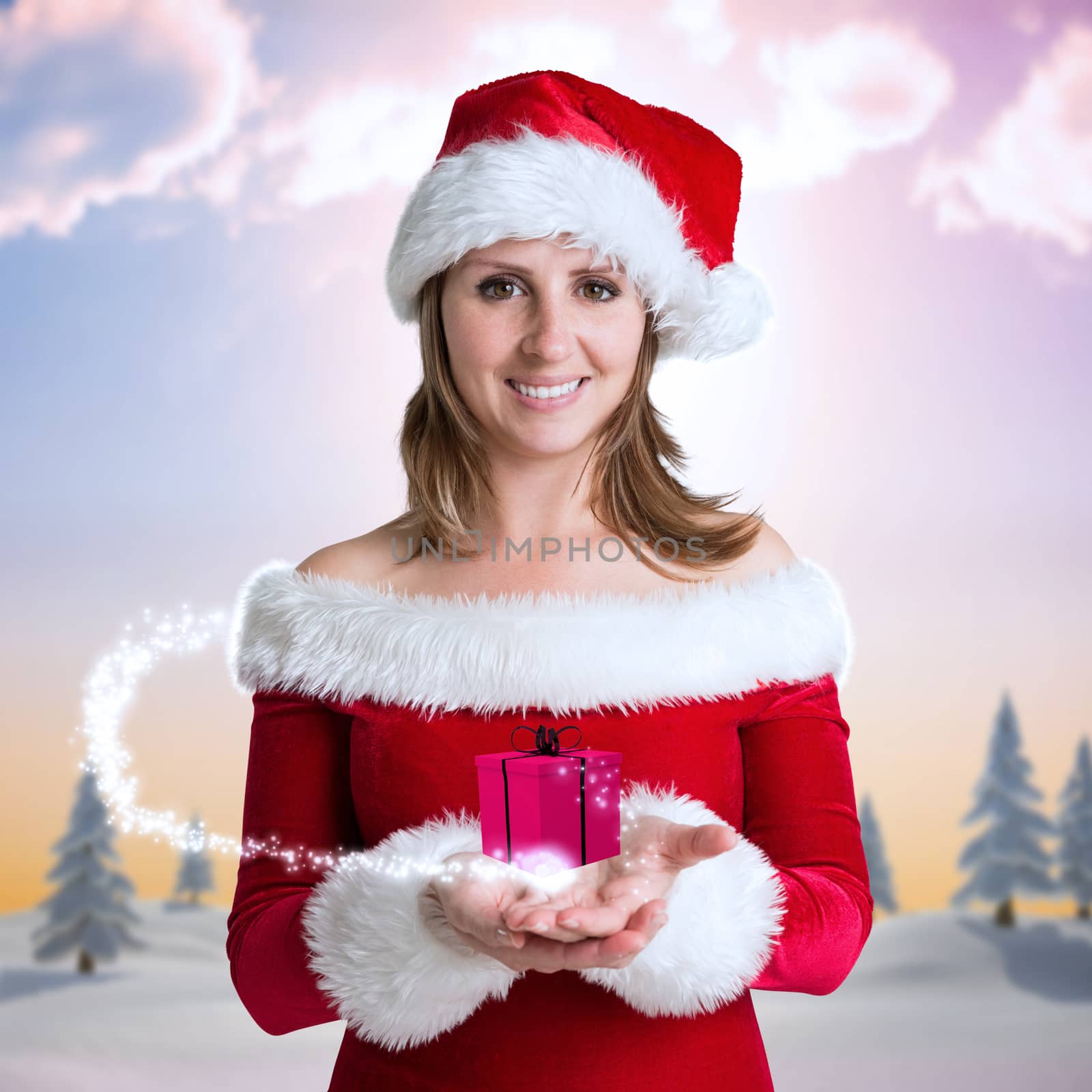 Pretty girl in santa outfit against snowy landscape with fir trees