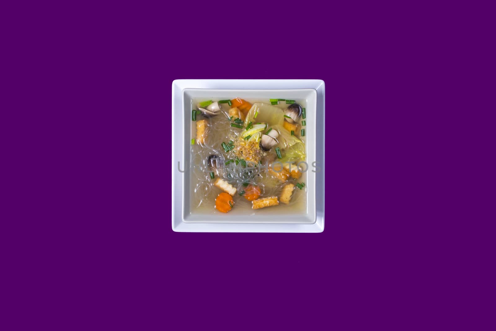 Tom seed tofu. Asian Thai food on white plates with purple background with copy space