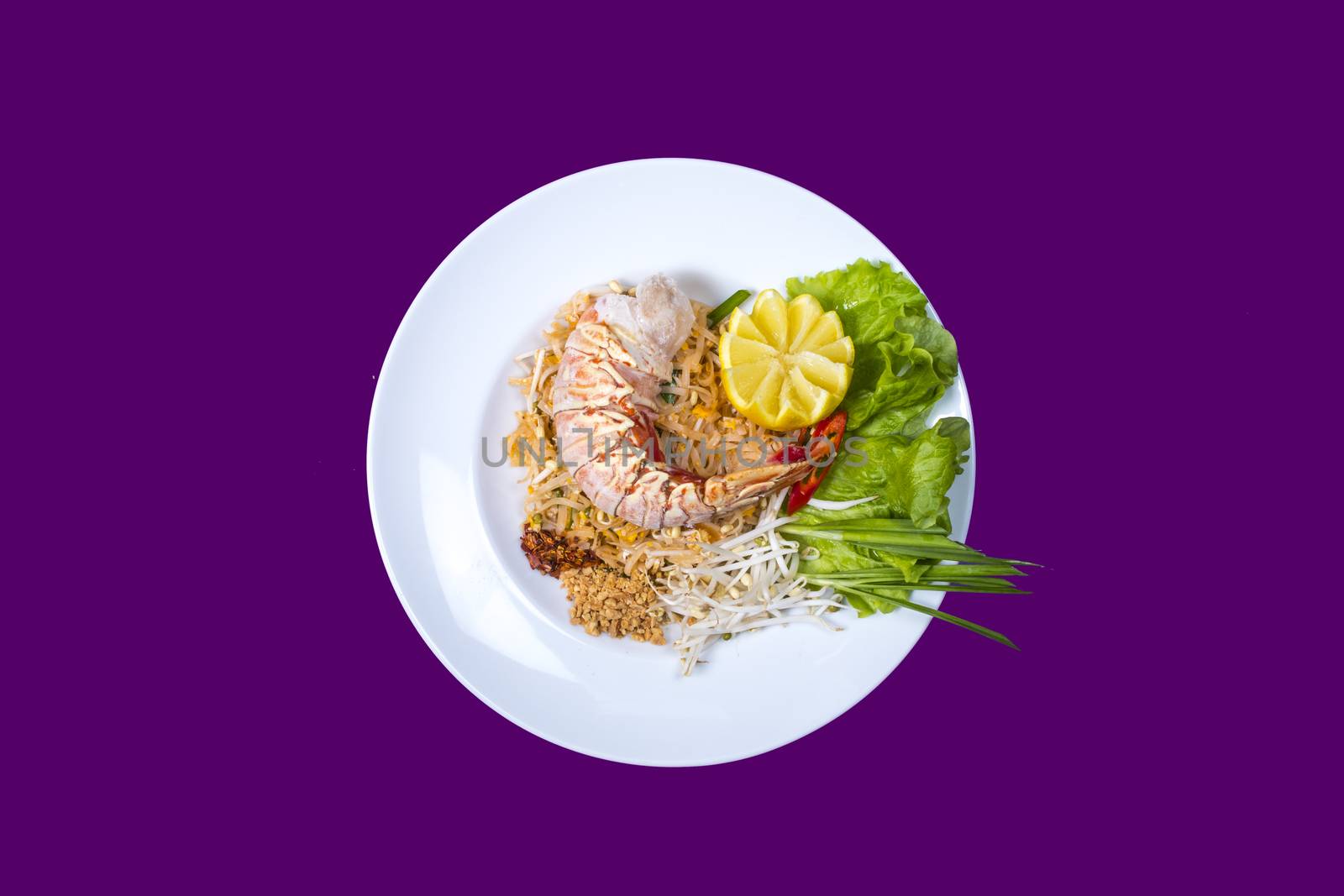 pad thai with lobster. Asian food with purple background and copy space