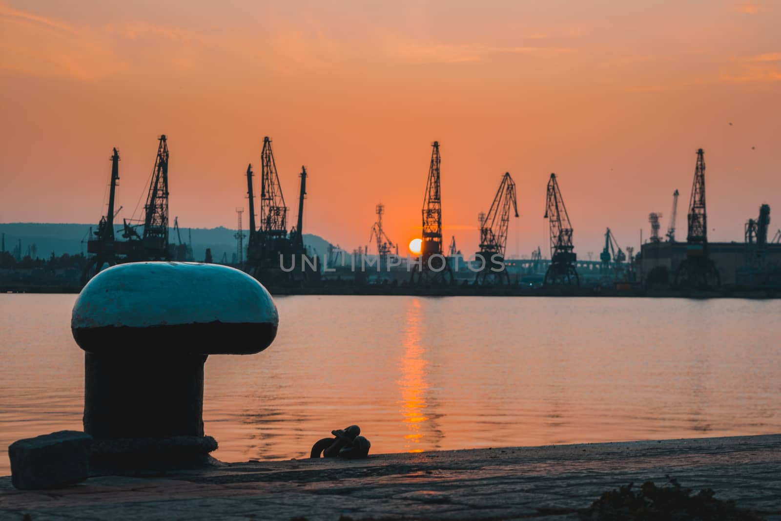 Sunset at golden hour in the port reflecting in the water. by justbrotography