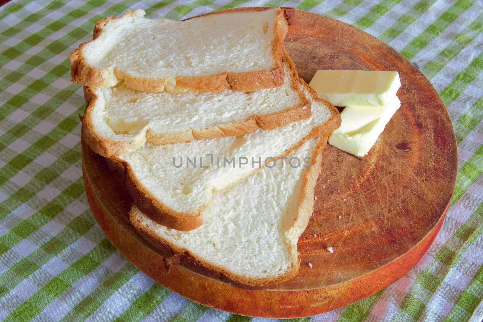 slices of artisan bread with butter on a wooden board