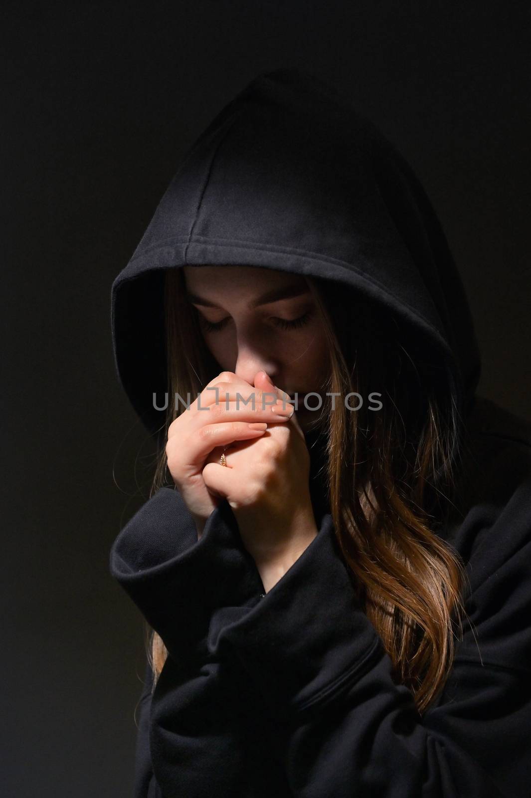 Young Woman Hands Praying in Dark