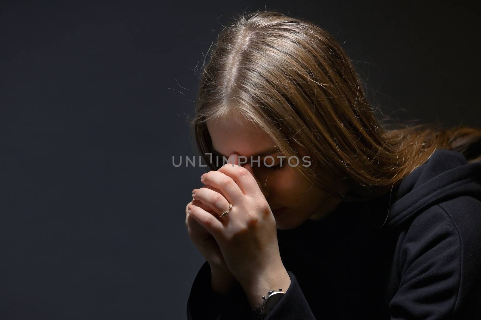 Young Woman Hands Praying in Dark