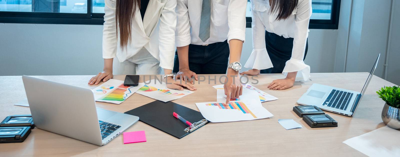 Business people are meeting and graphing business growth on a desk