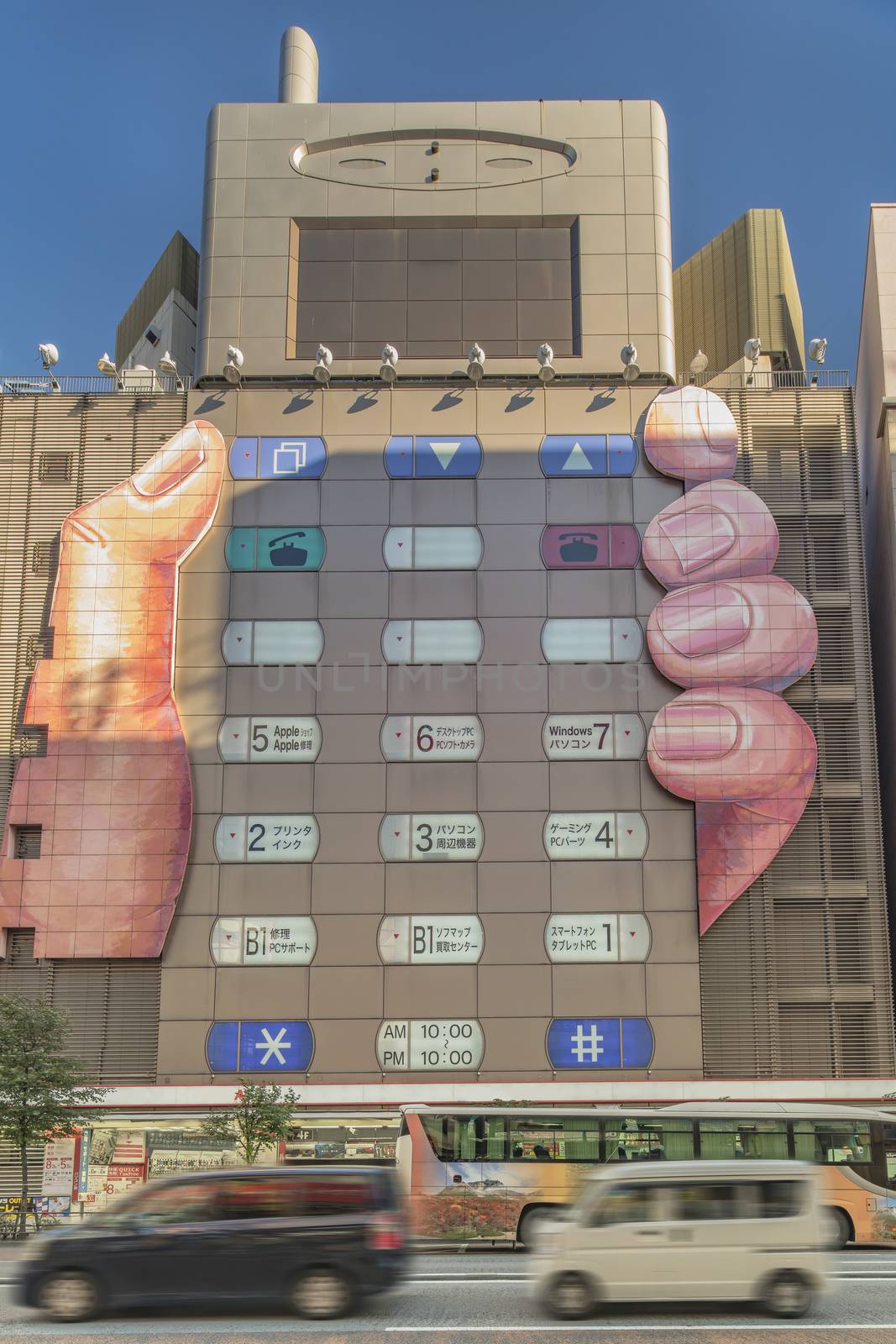 Building of a consumer electronics shopping center shaped in a form of a mobile phone held in one hand where the windows are button-shaped in Ikebukuro district north of Tokyo