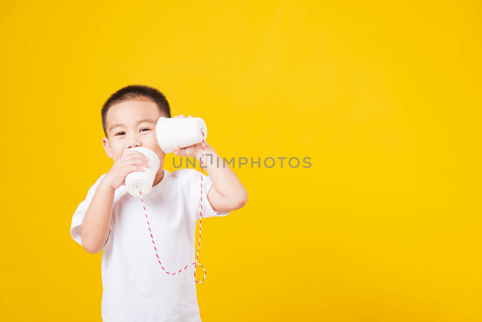 little children boy smile standing so happy playing paper can te by Sorapop