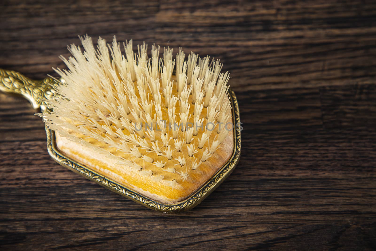 close up of a vintage brush head against a wood background