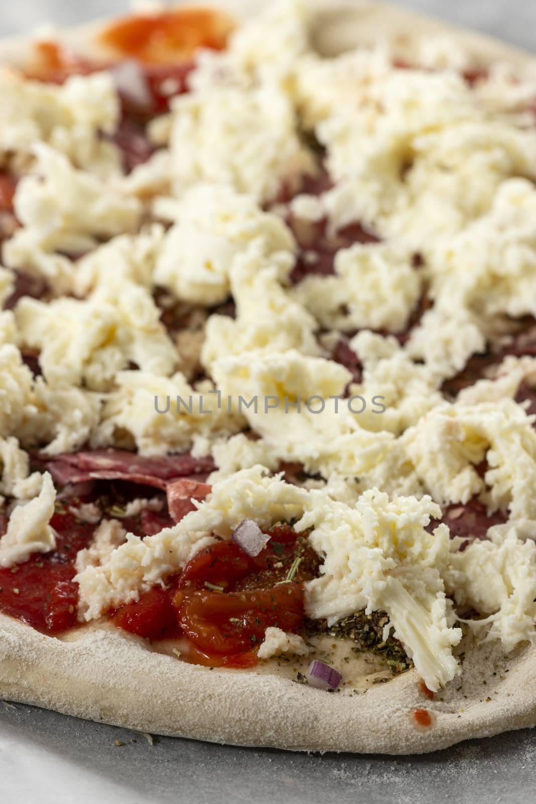 raw pizza on a plate with arugula