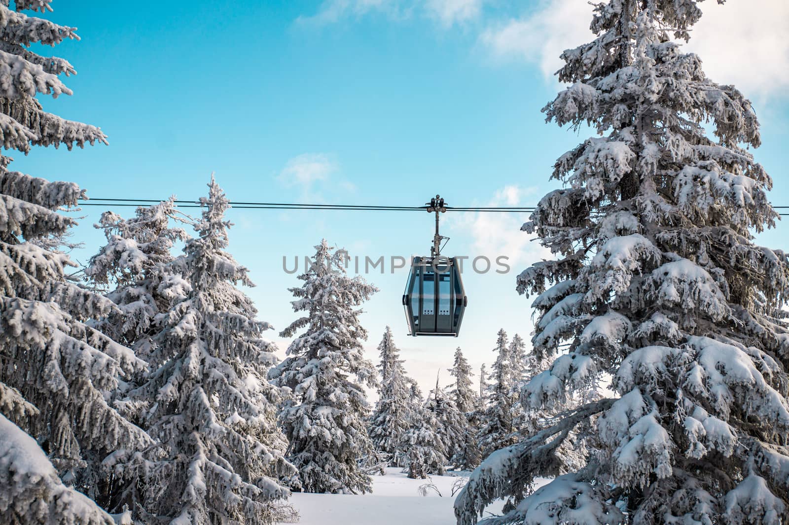 Sunshine over cable car covered with snow during winter. Cable car to Snezka in Krkonose. Cableway in Krkonose. by petrsvoboda91
