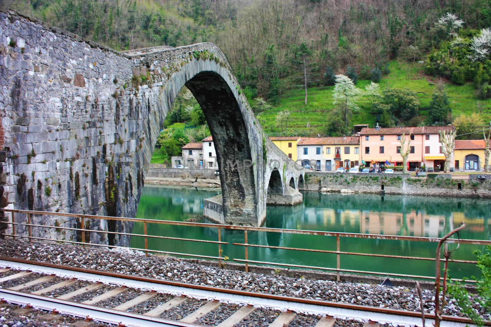 The suggestive and famous Ponte del Diavolo of Lucca built in bricks over a river in an ancient medieval village in Borgo a Mozzano by alessiapenny90