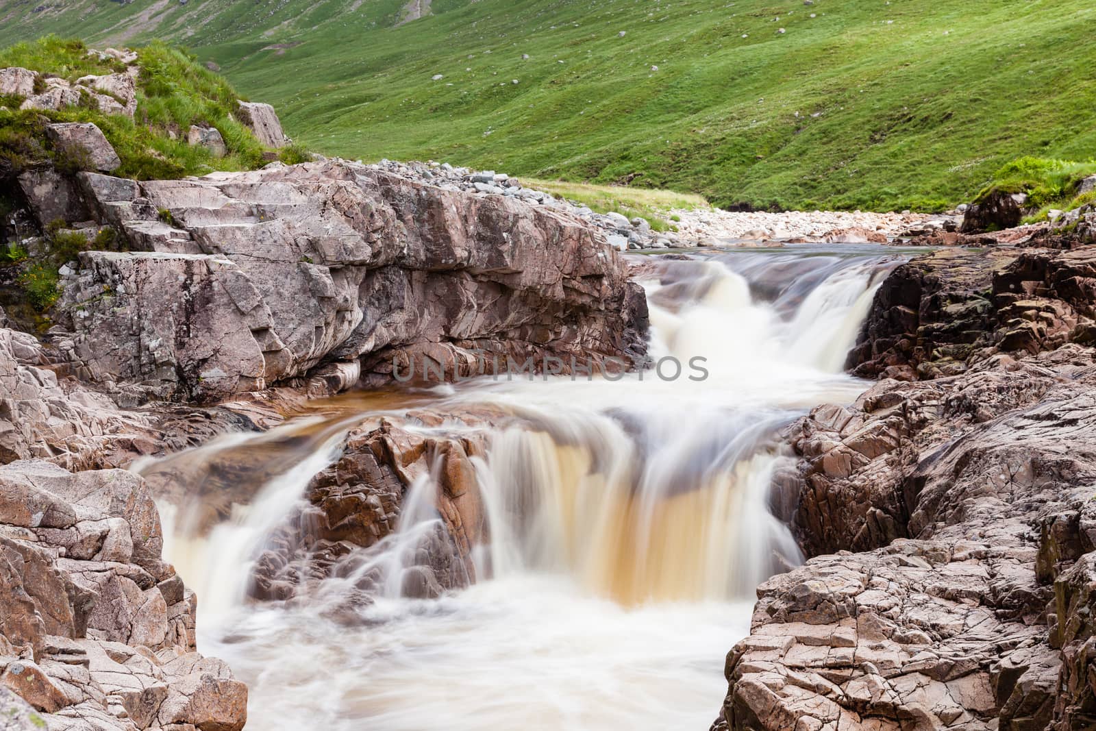 Water cascades down the River Etive in Glen Etive in the Scottish highlands.