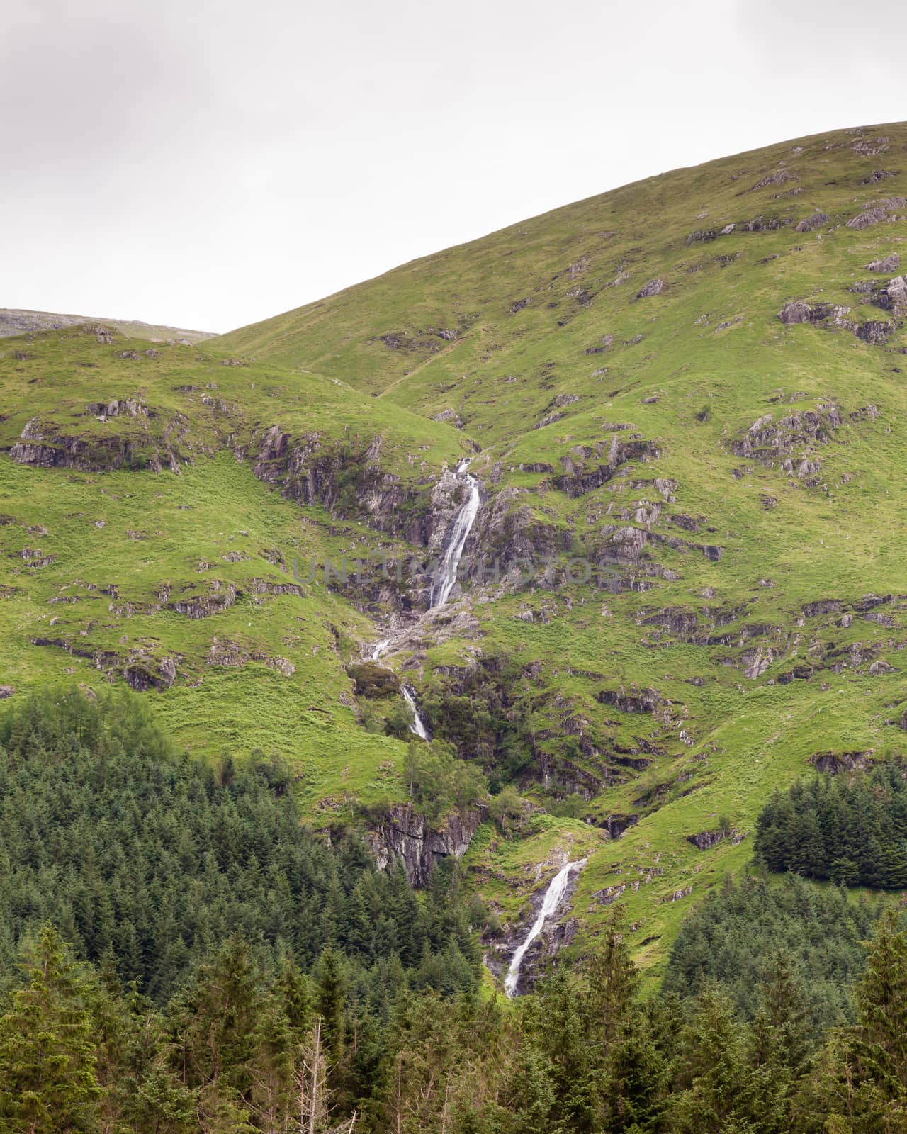 A stream cascades down the hillside of Glen Etive in the Scottish highlands.