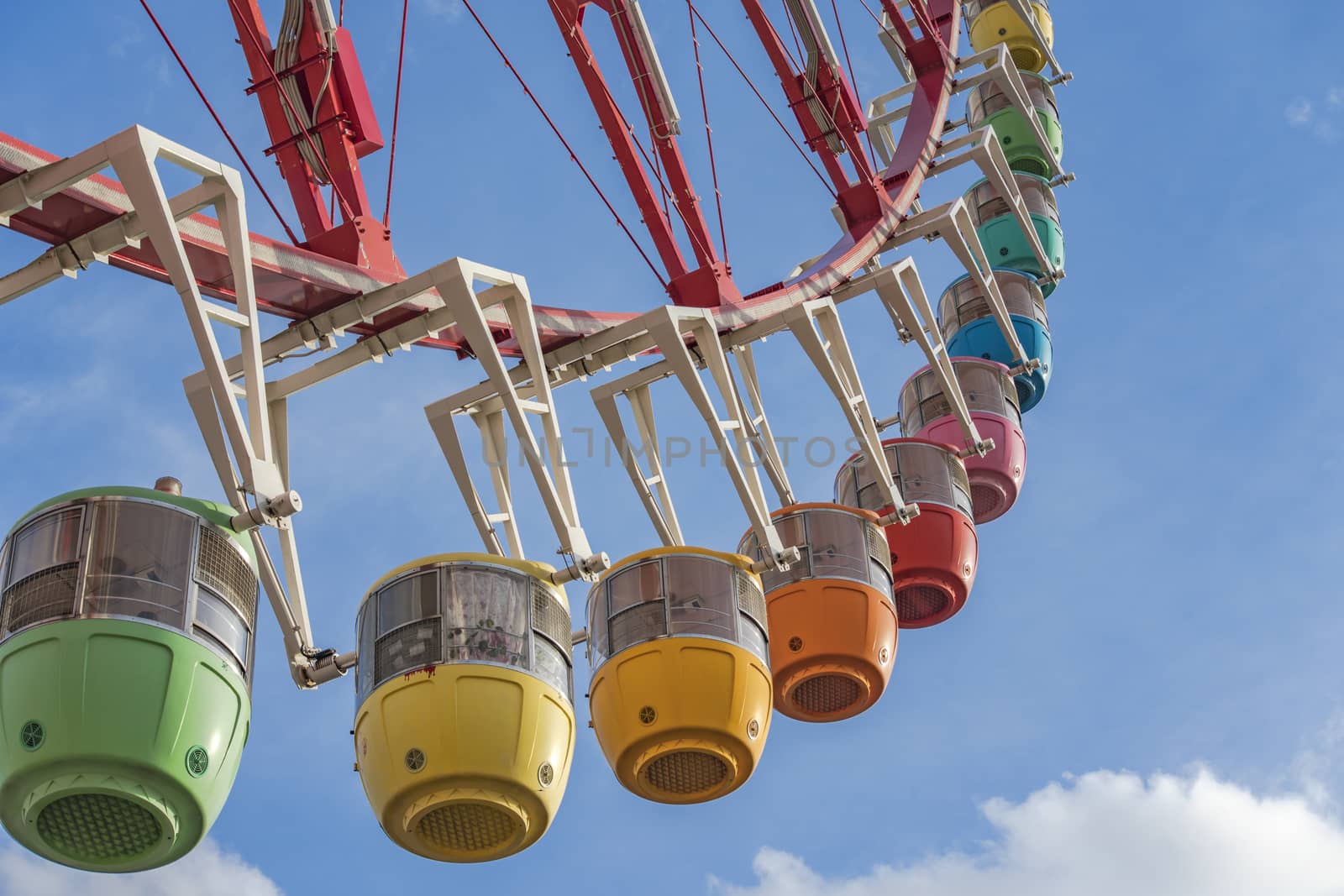 Odaiba colorful tall Palette Town Ferris wheel named Daikanransha visible from the central urban area of Tokyo. Passengers can see the Tokyo Tower, the twin-deck Rainbow Bridge, and Haneda Airport, as well as central Tokyo during their ride.