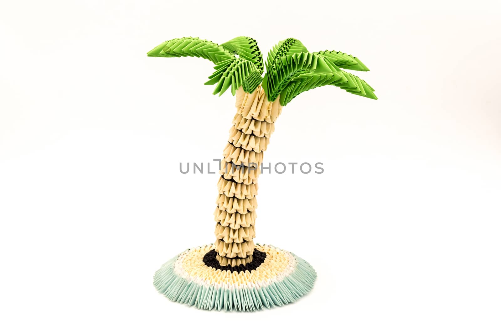 Palm tree constructed from paper on white background