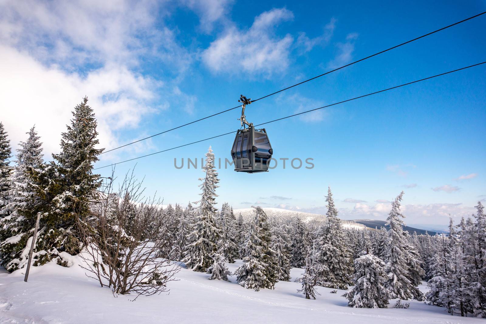 Beautiful winter landscape with snow covered trees and cable car travel. Krkonose, Pec pod Snezkou.