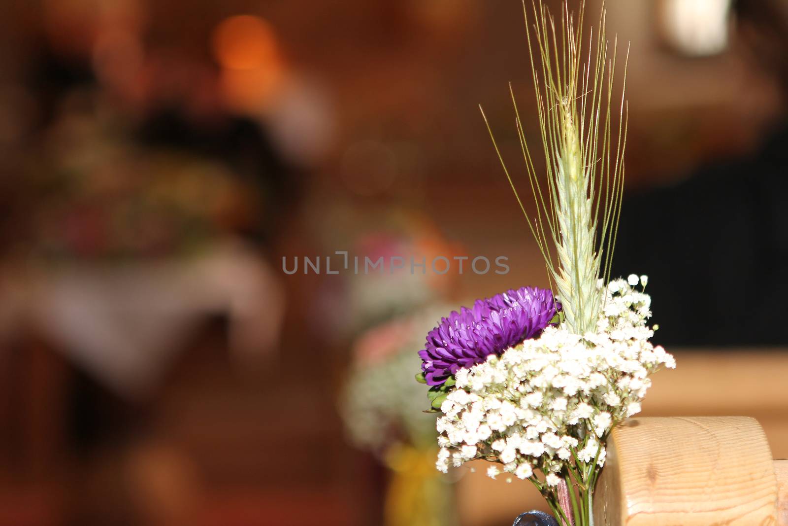 wedding flower in Church seats. white and yellow flowers with green leafs