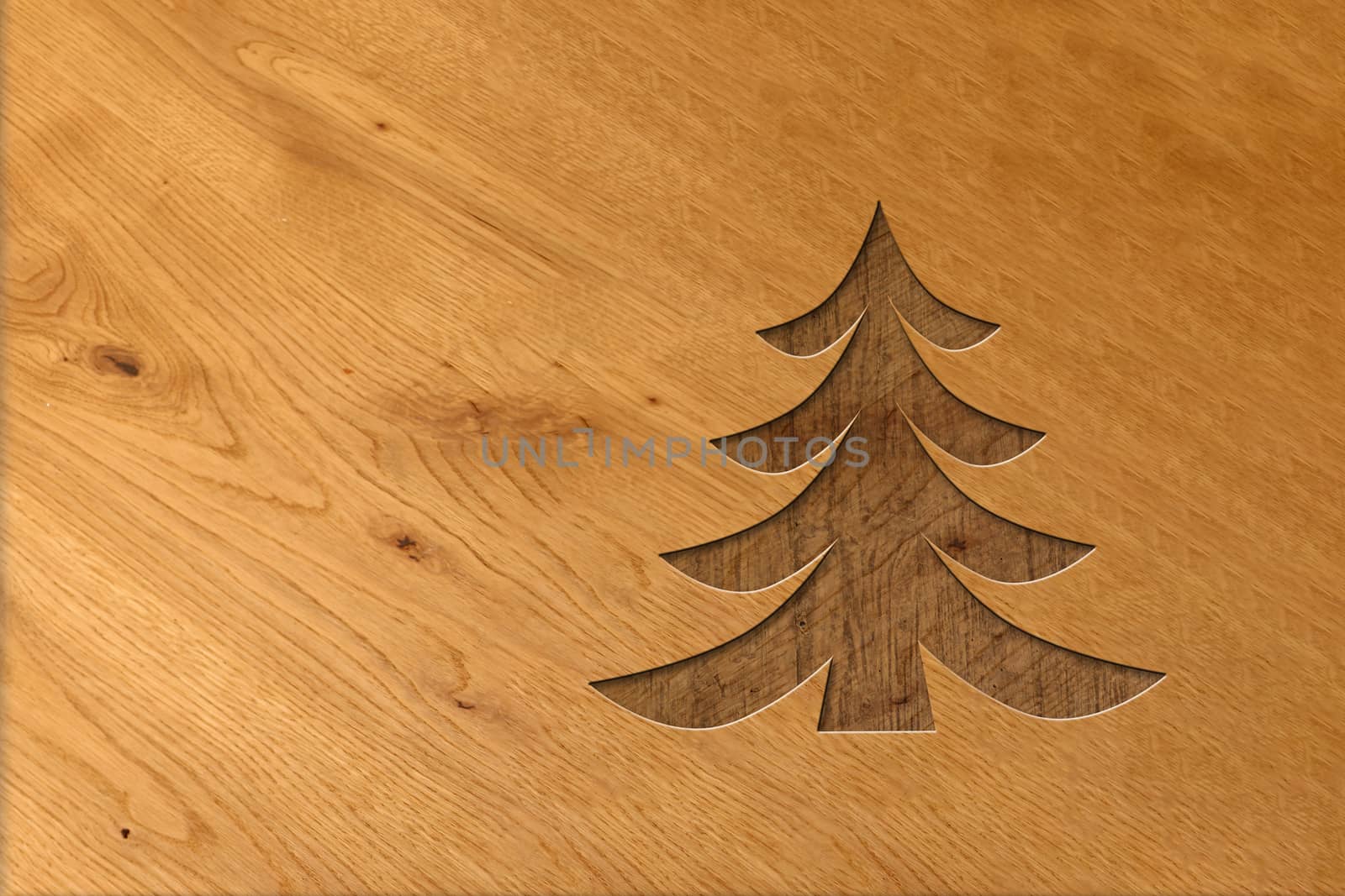Christmas tree carved in wood. Wood workers christmas design with light and dark wood
