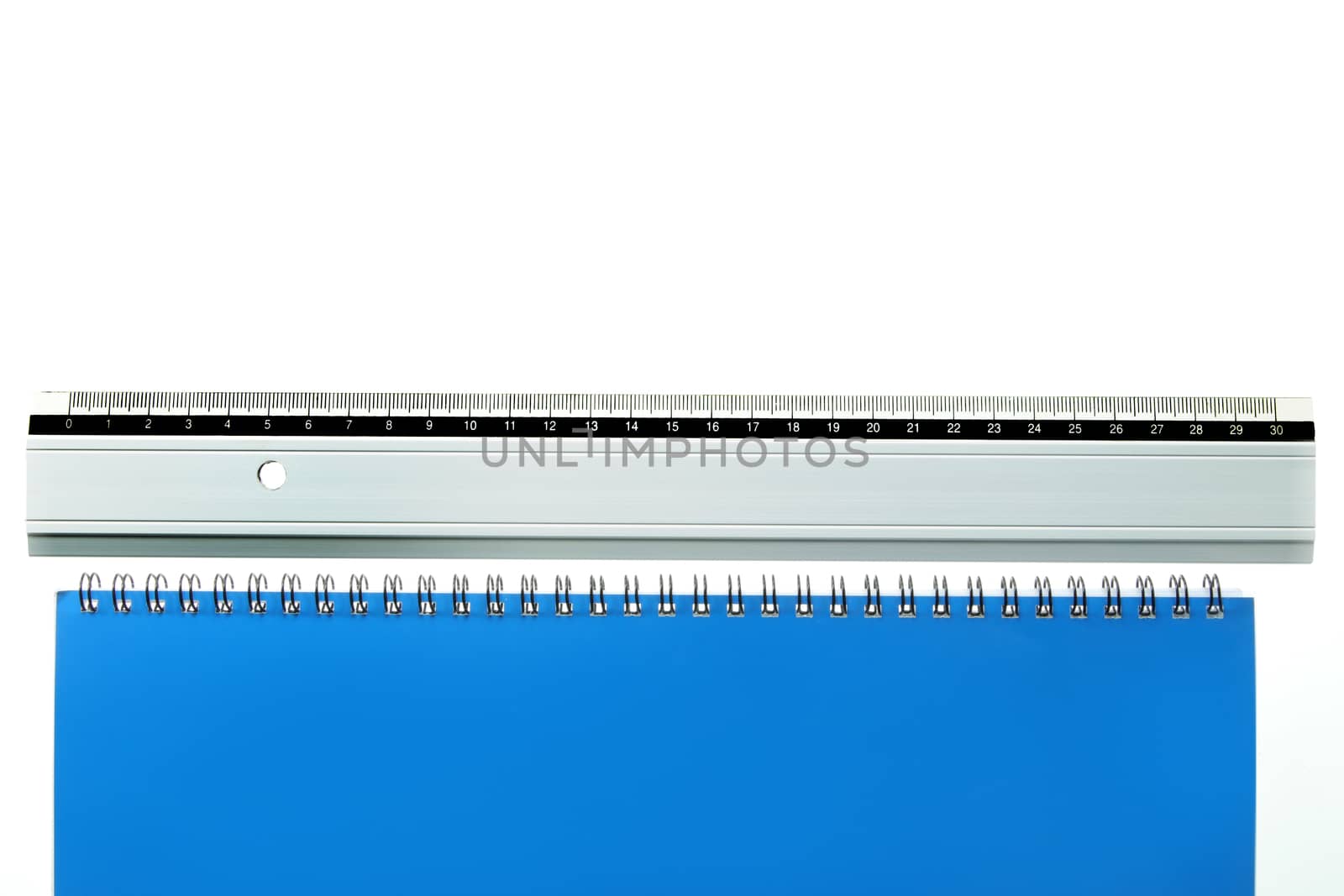 ruler laying straight at bottom of a white and blue page with copy space