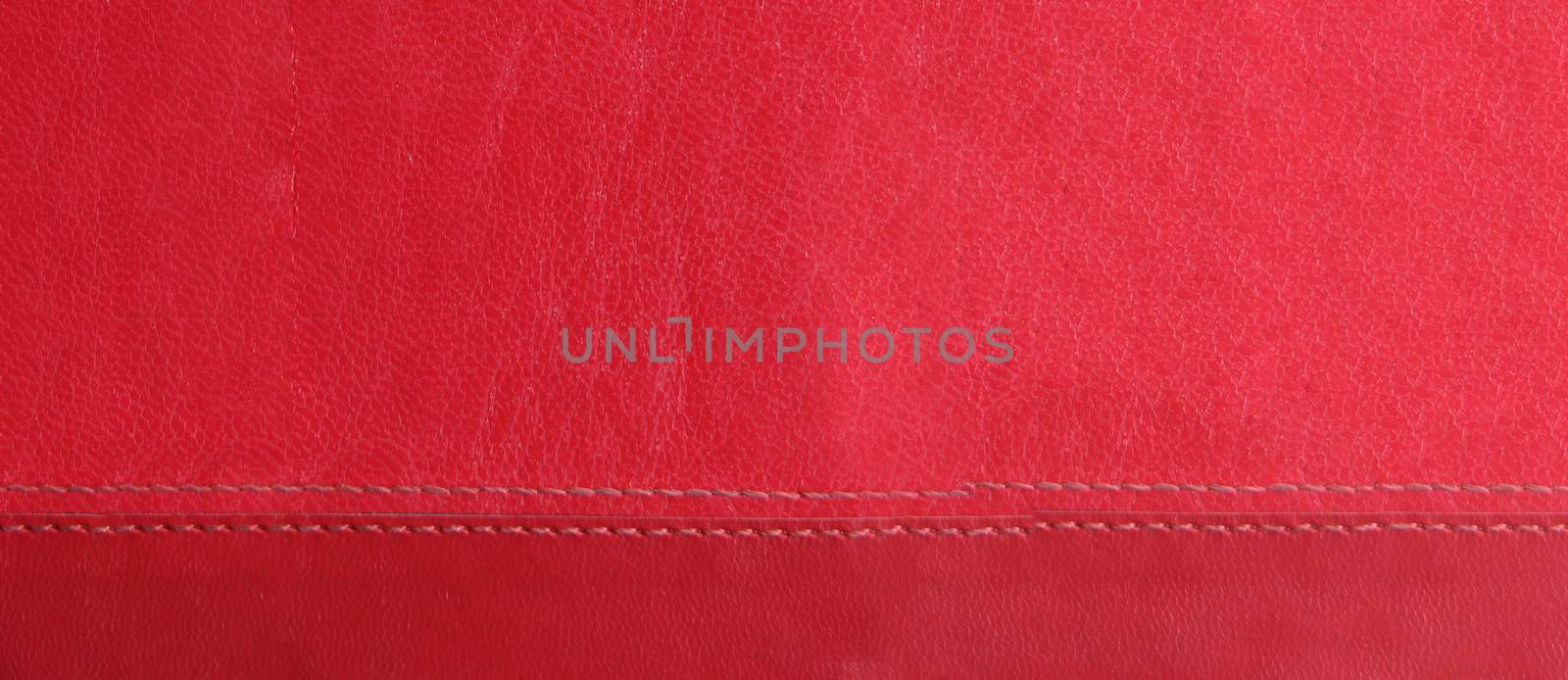 red leather background with red stitches at the bottom