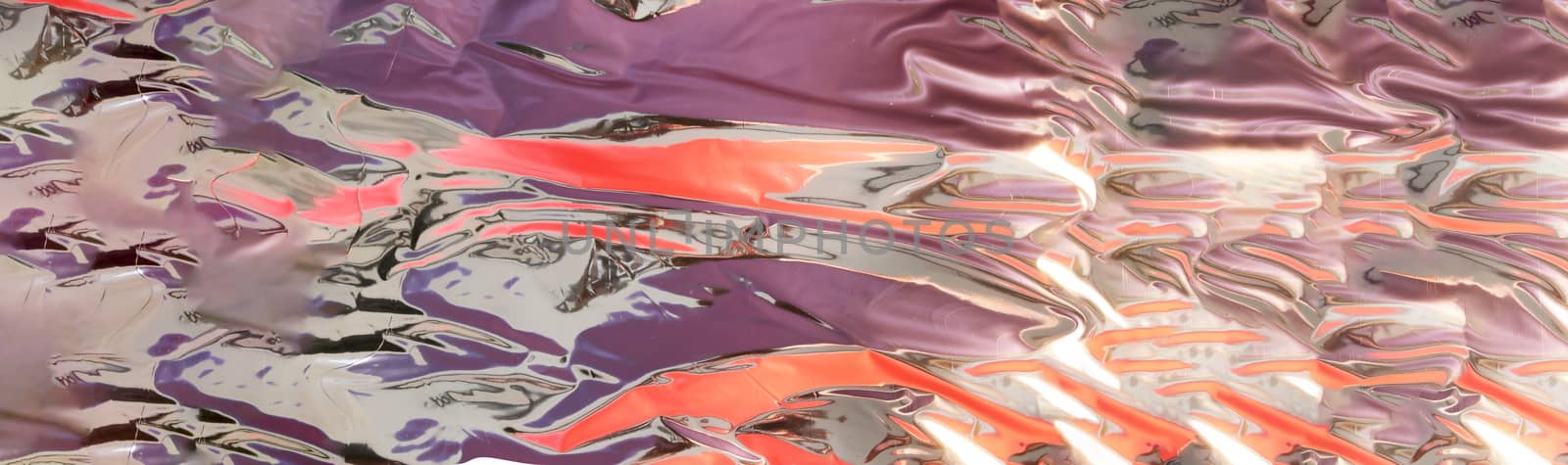 silver - mercury looking background with shinny purple and orange reflection with copy space,