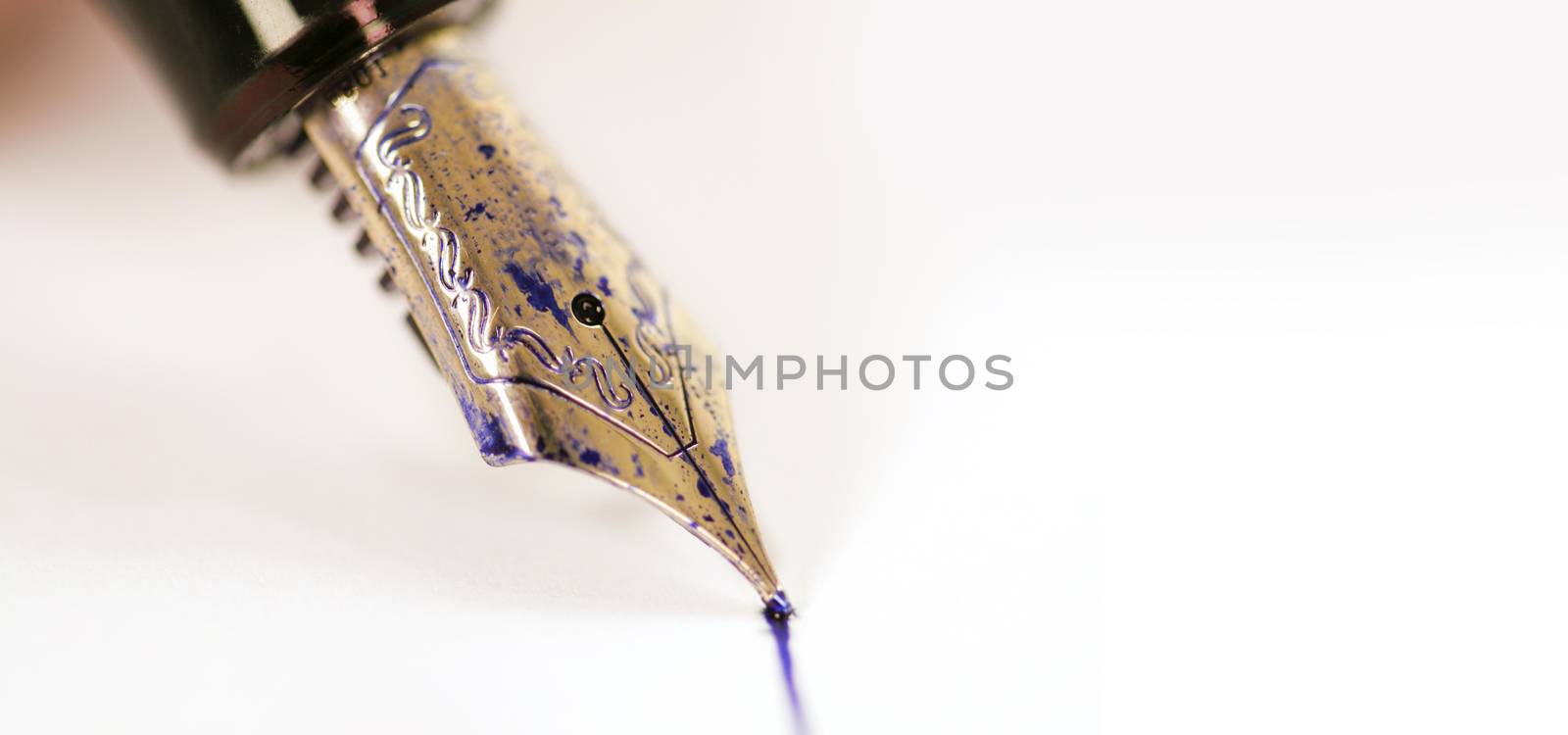 fountain pen with ink on white paper background. White background