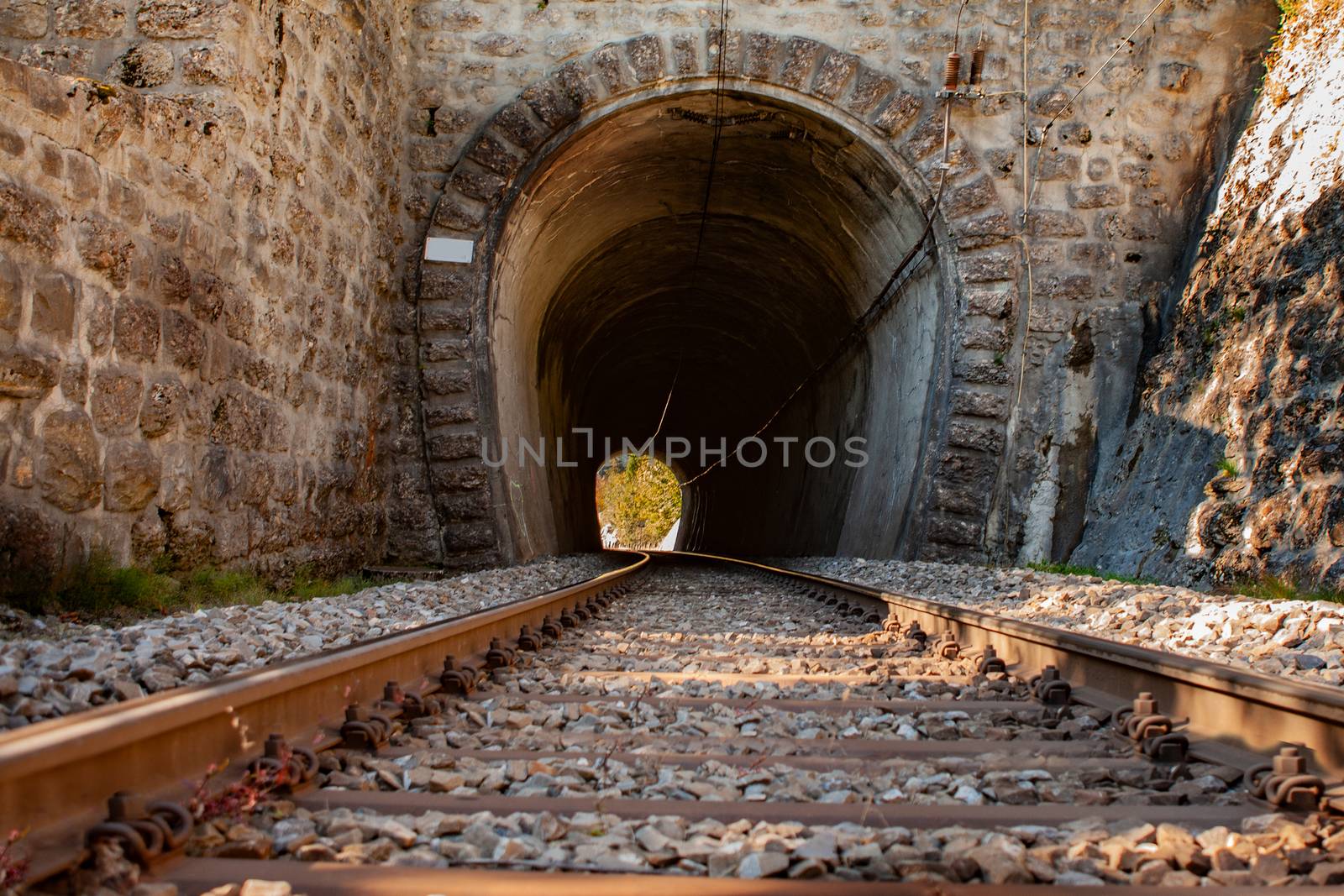 rail road tracks leading into a dark tunnel in Switzerland