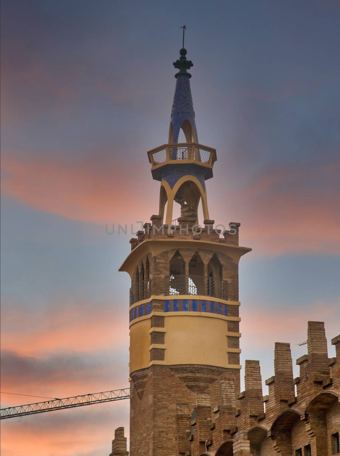 A church bell tower in Barcelona, Spain with blue tiles in the Gaudi style