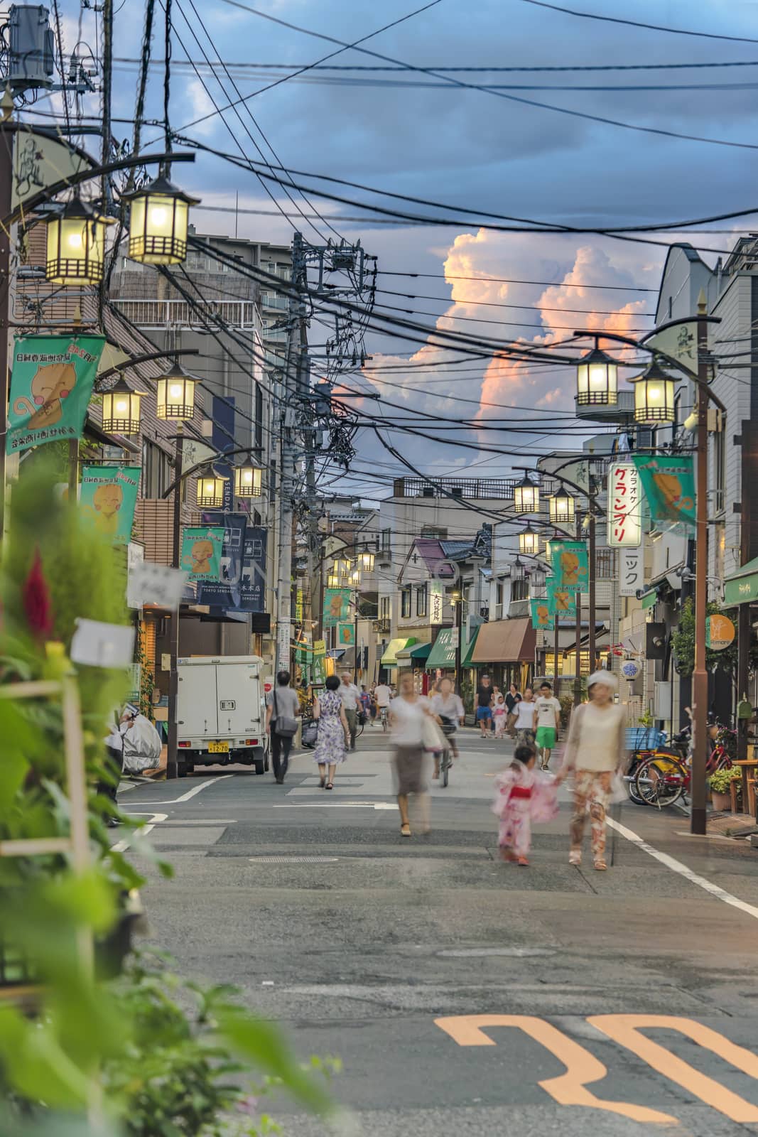 Retro old-fashionned shopping street Yanaka Ginza famous as a spectacular spot for sunset golden hour from the Yuyakedandan stairs which means Dusk Steps at Nishi-Nippori in Tokyo. Yanaka Ginza is also named the Evening Village.
