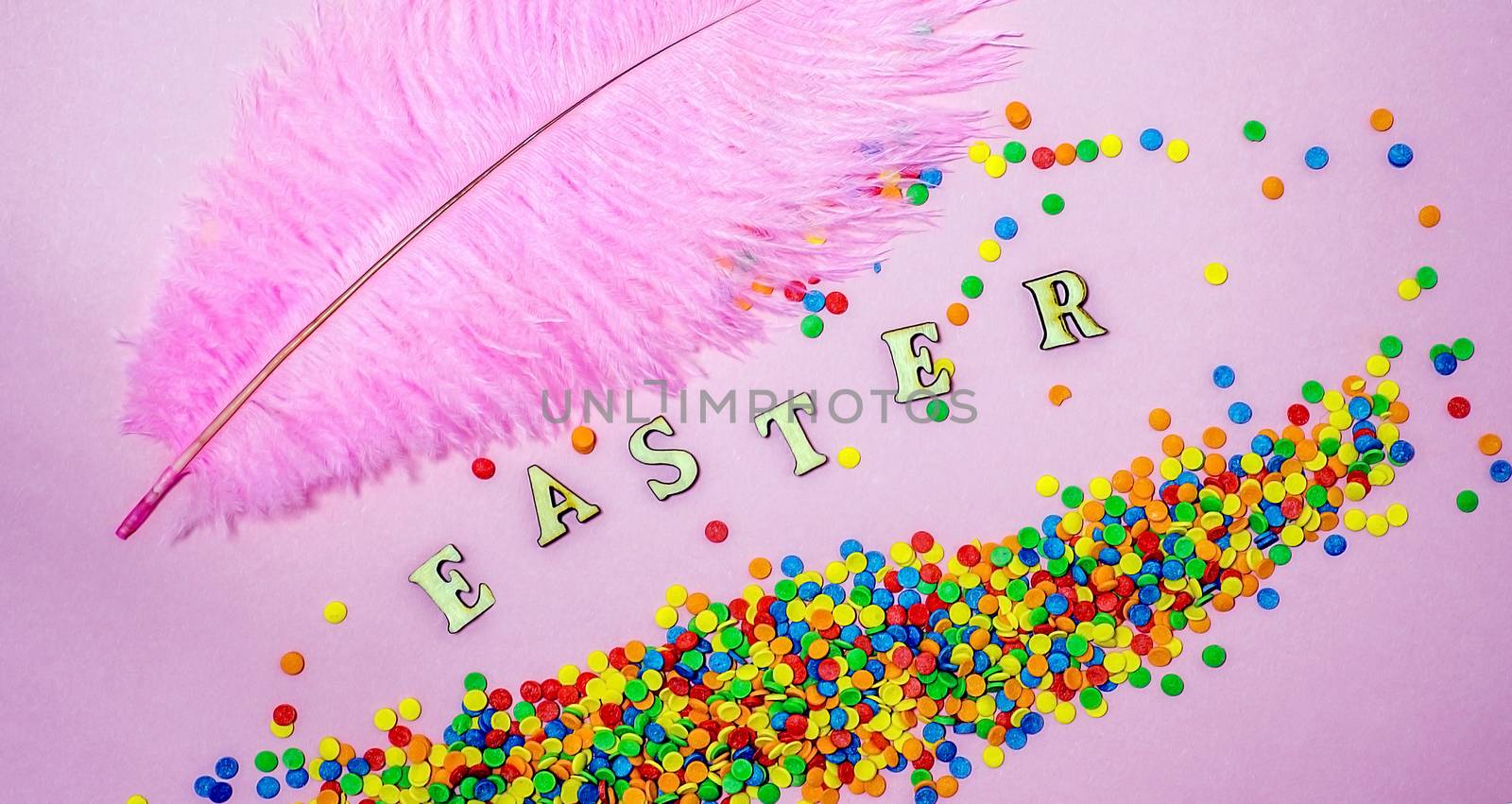 Abstract easter card with scattered color confectionery balls and letters. Easter holiday concept. by AlisLuch