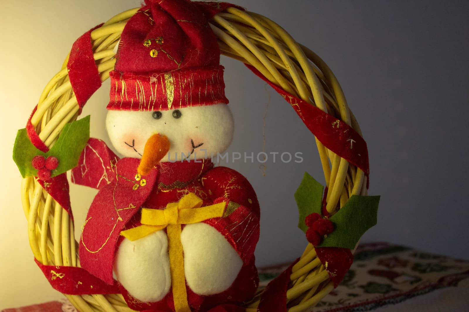 A christmas garland made of bamboo with a ahppy snowman dressed for christmas