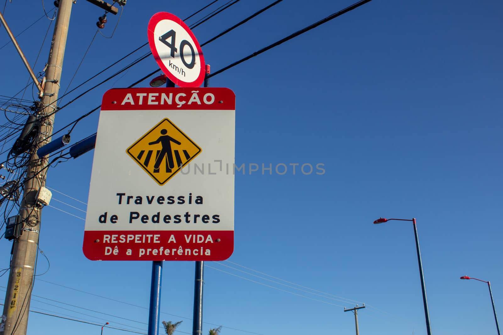 Speed sign showing 40kmh and an warning sign saying "Atention, Pedestrian Crossing, Respect the life, give preference".