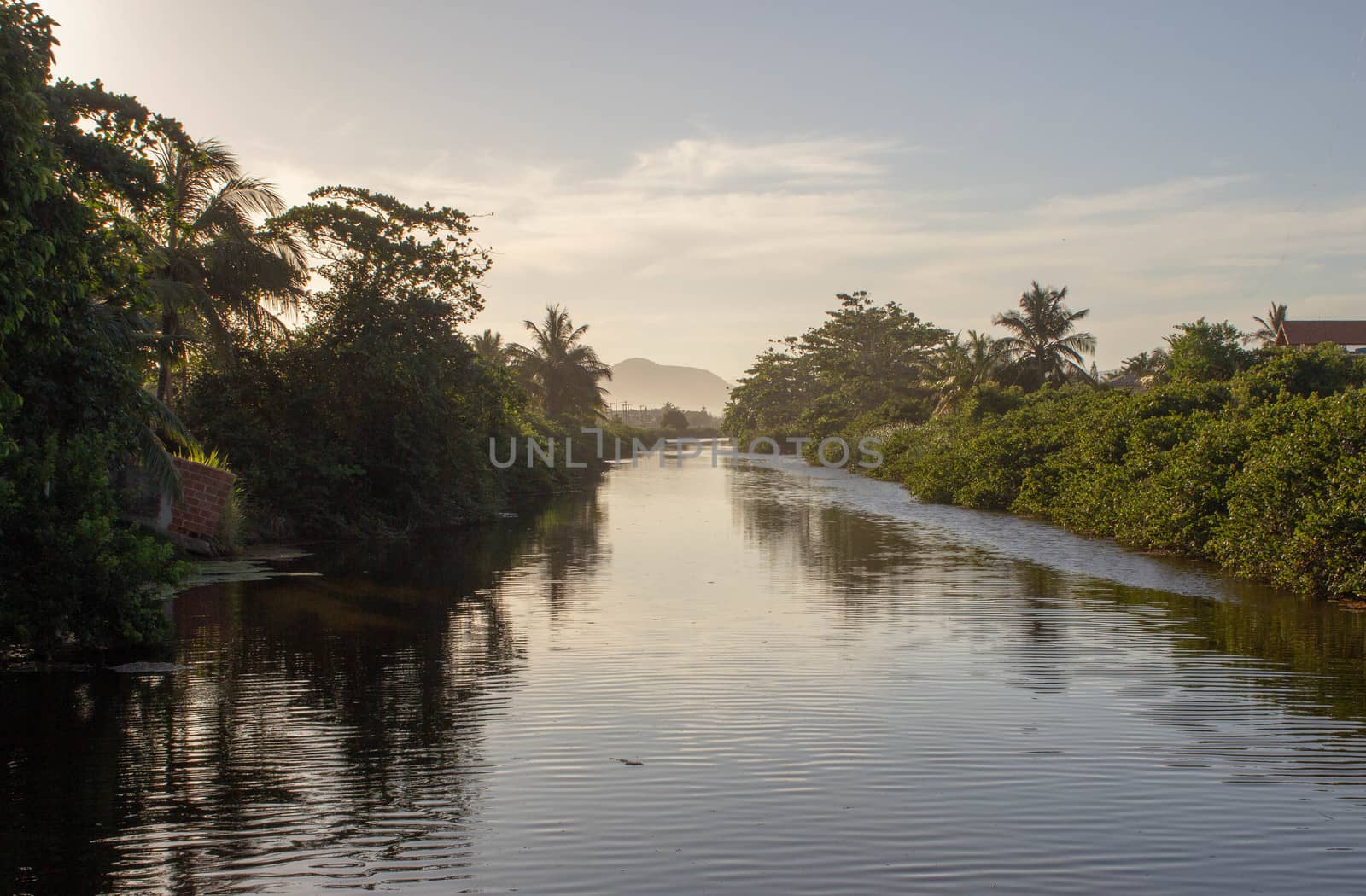 City canal of Itaipuaçu, Rio de Janeiro, during the sunset with beautiful reflexions on the water