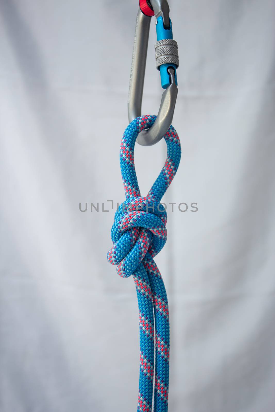Overhand knot tied with a climbing rope to a pear shaped locking carabiner