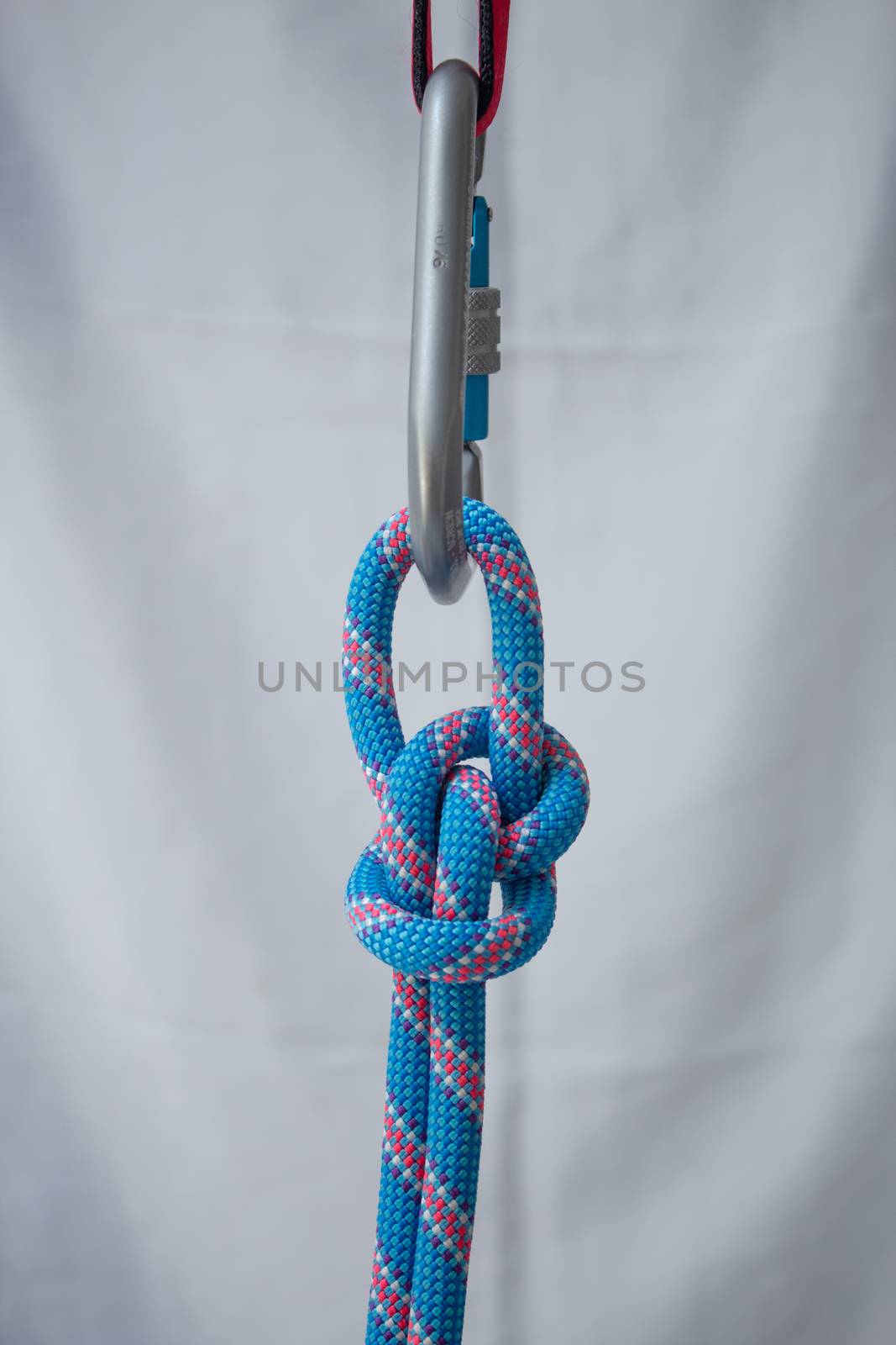 Bowline knot tied with a climbing rope to a pear shaped locking carabiner