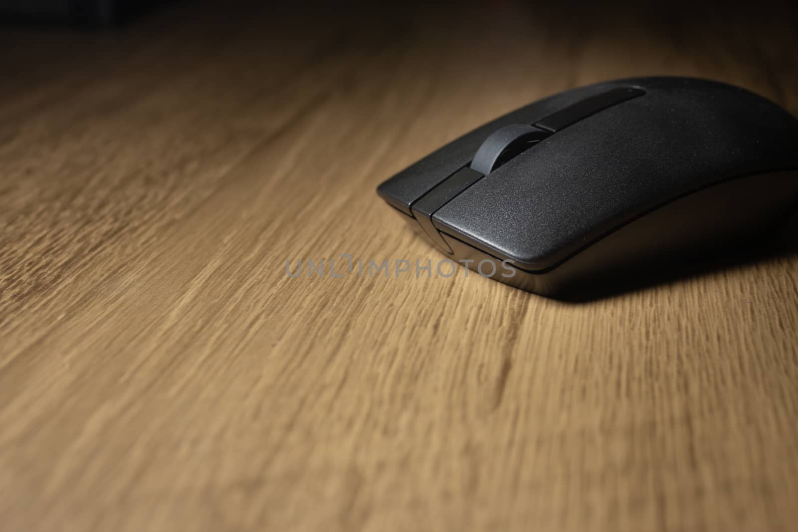 Wireless mouse on a wooden office desk