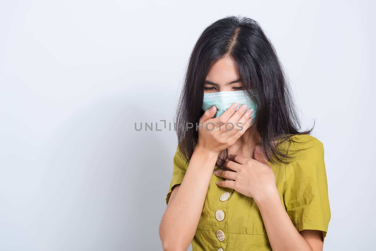 Portrait Asian beautiful happy young woman wearing face mask protects filter dust pm2.5 anti-pollution, anti-smog, and air pollution her sneezing in mask on a white background, with copy space