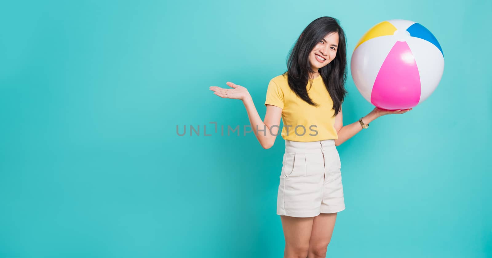 woman smiling standing wear shirt her holding beach ball in summ by Sorapop