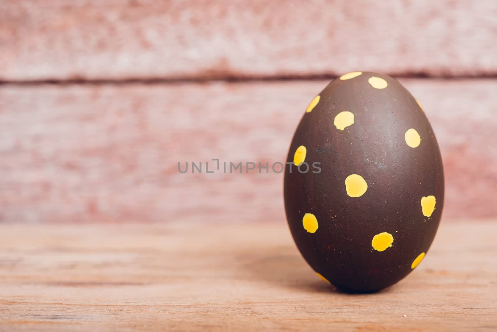Beautiful Easter Brown egg on wooden background, Easter day concept