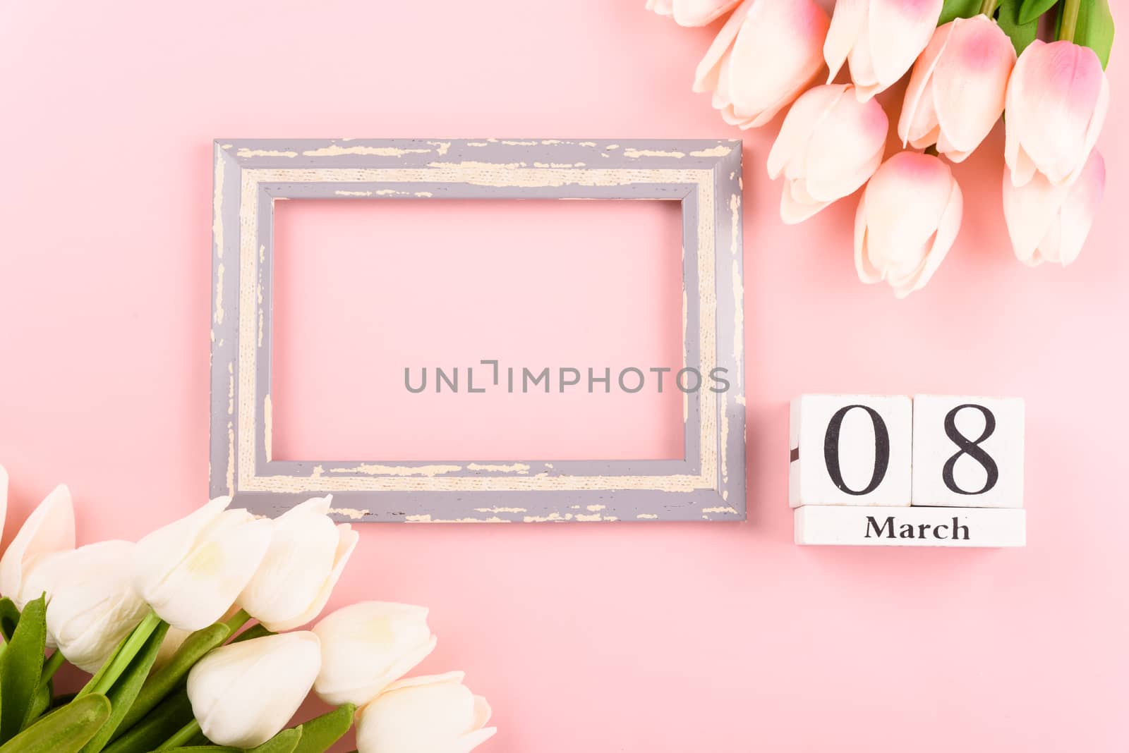 Happy Women's Day, Mother's Day concept. top view flat lay Tulip flower and photo frame on pink background, copy space for your text