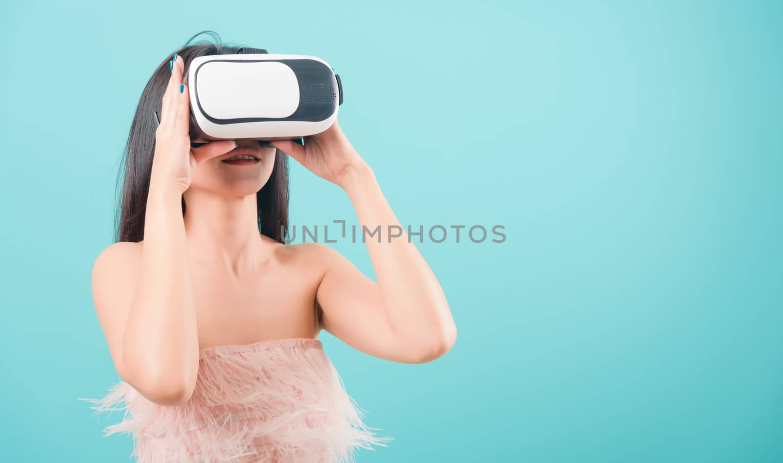 woman standing smile her using a virtual reality headset by Sorapop