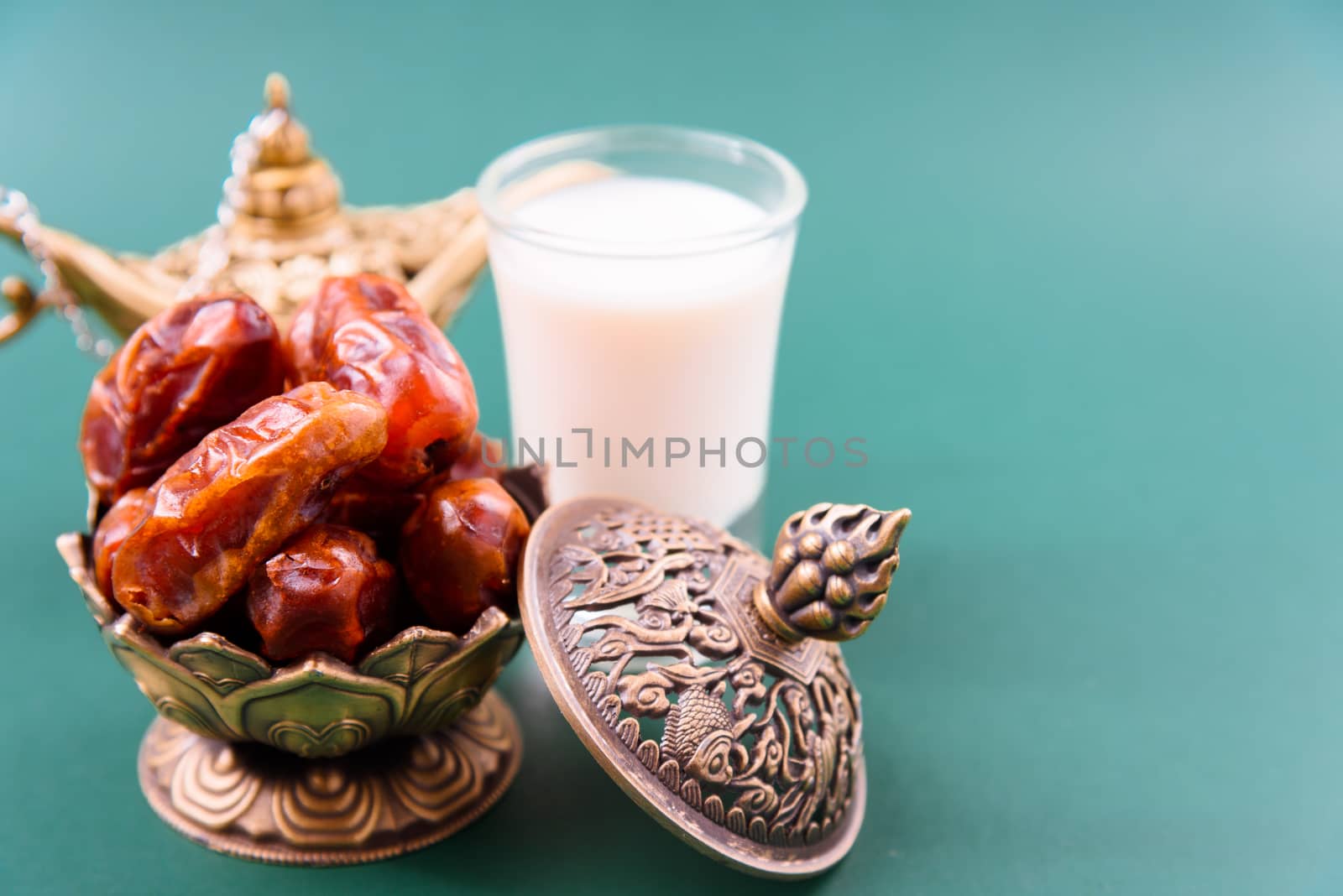 Ramadan, Dates in golden bowl, Milk, arabian Aladdin golden lamp vintage style on black green background